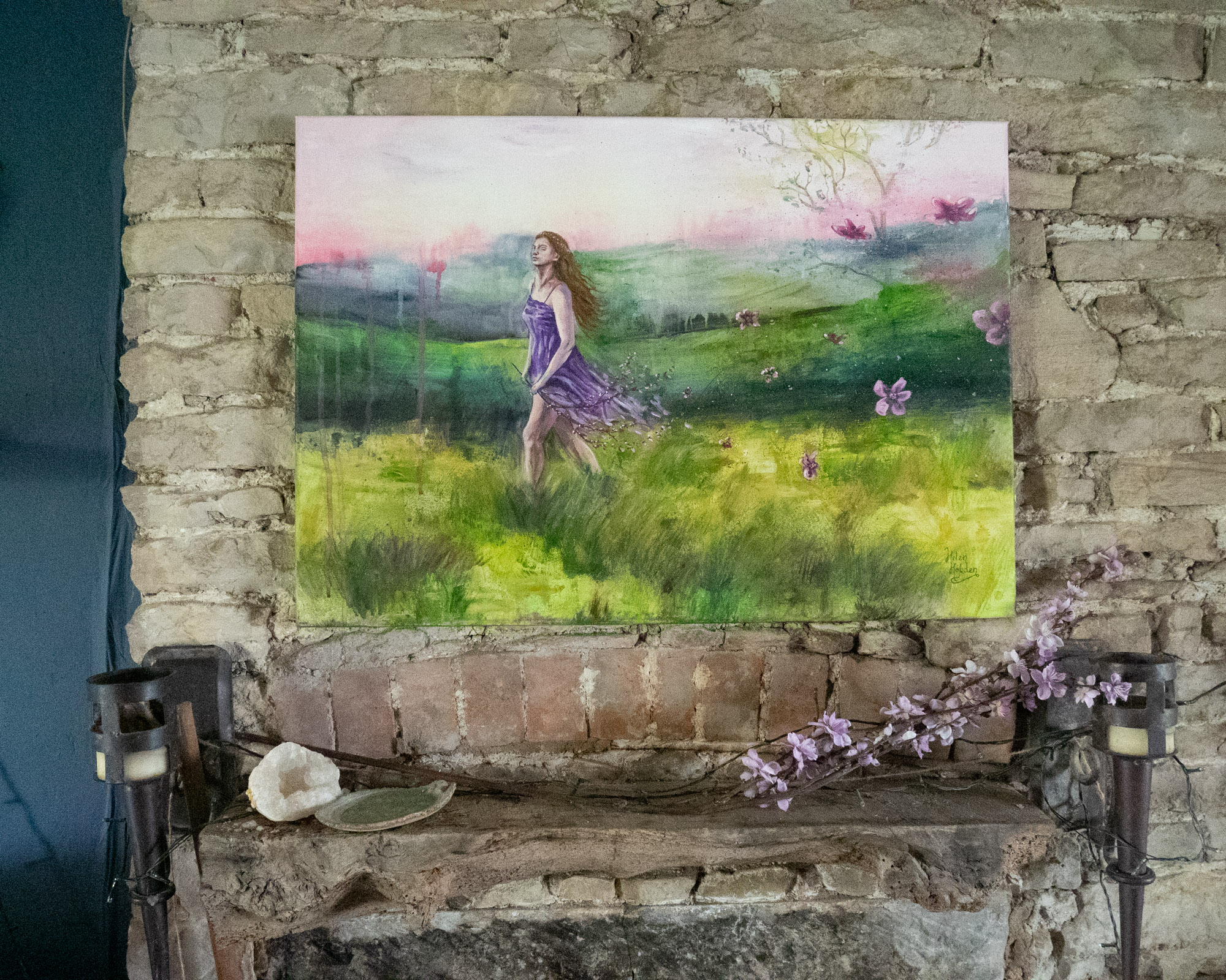 A modern fairytale painting of a woman walking through a meadow. The colours are green, purple and pink.