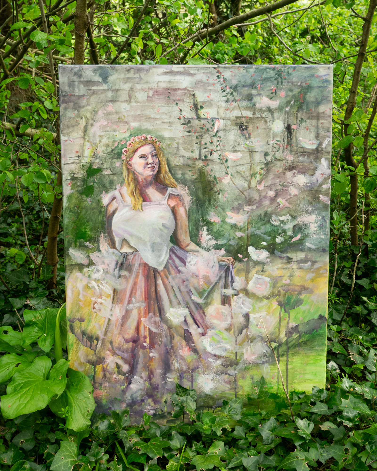 A fairytale painting of a woman in white with white spring blossom floating around her.